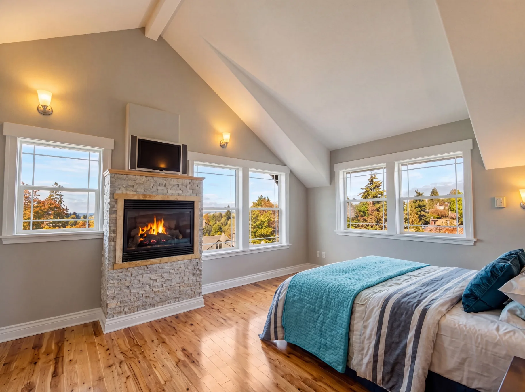 Master bedroom addition with stone fireplace by Premier Building & Construction